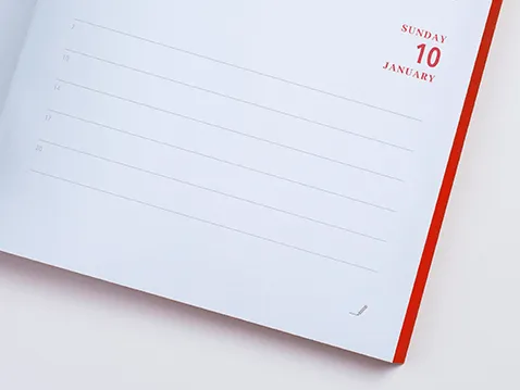 Close-up of an A5 daily diary page with red printed page edges
