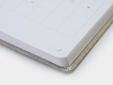Close-up of the rounded corner and page block of an A5 daily diary