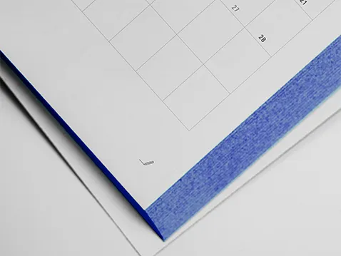 Close-up of an A5 weekly diary with blue printed page edges