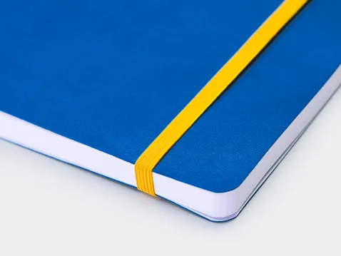 Close-up of a blue A5 weekly diary with yellow elastic band