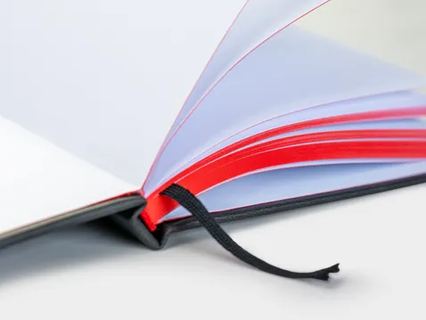 Close-up of the red page edges and black ribbon of an A5 diary