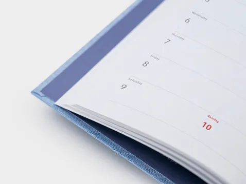 Close-up of the weekly layout in an A5 diary with a hard cover
