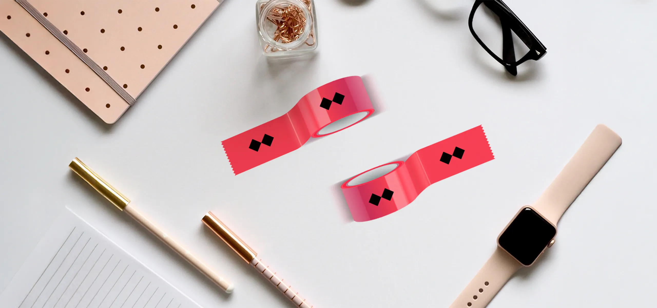 Pink self-adhesive tapes with print on a desk