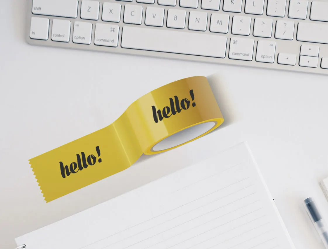 Yellow self-adhesive tape with print on a desk