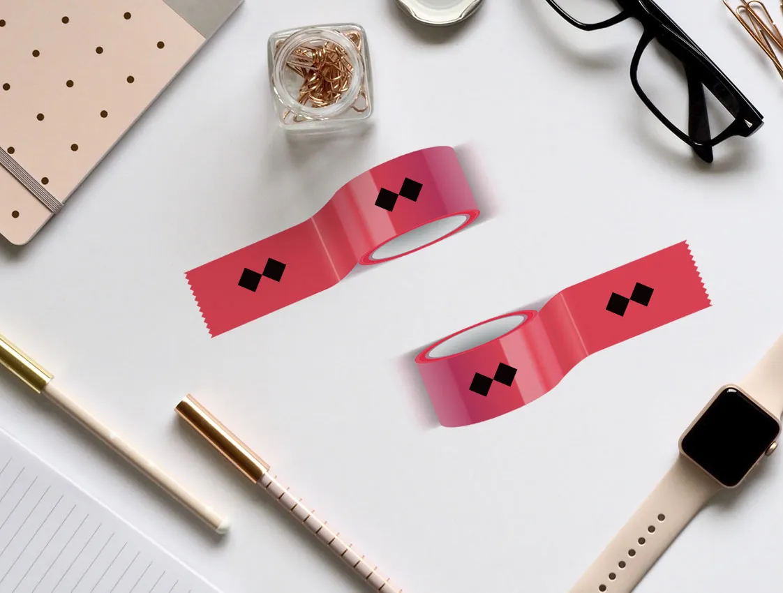 Pink self-adhesive tapes with print on a desk