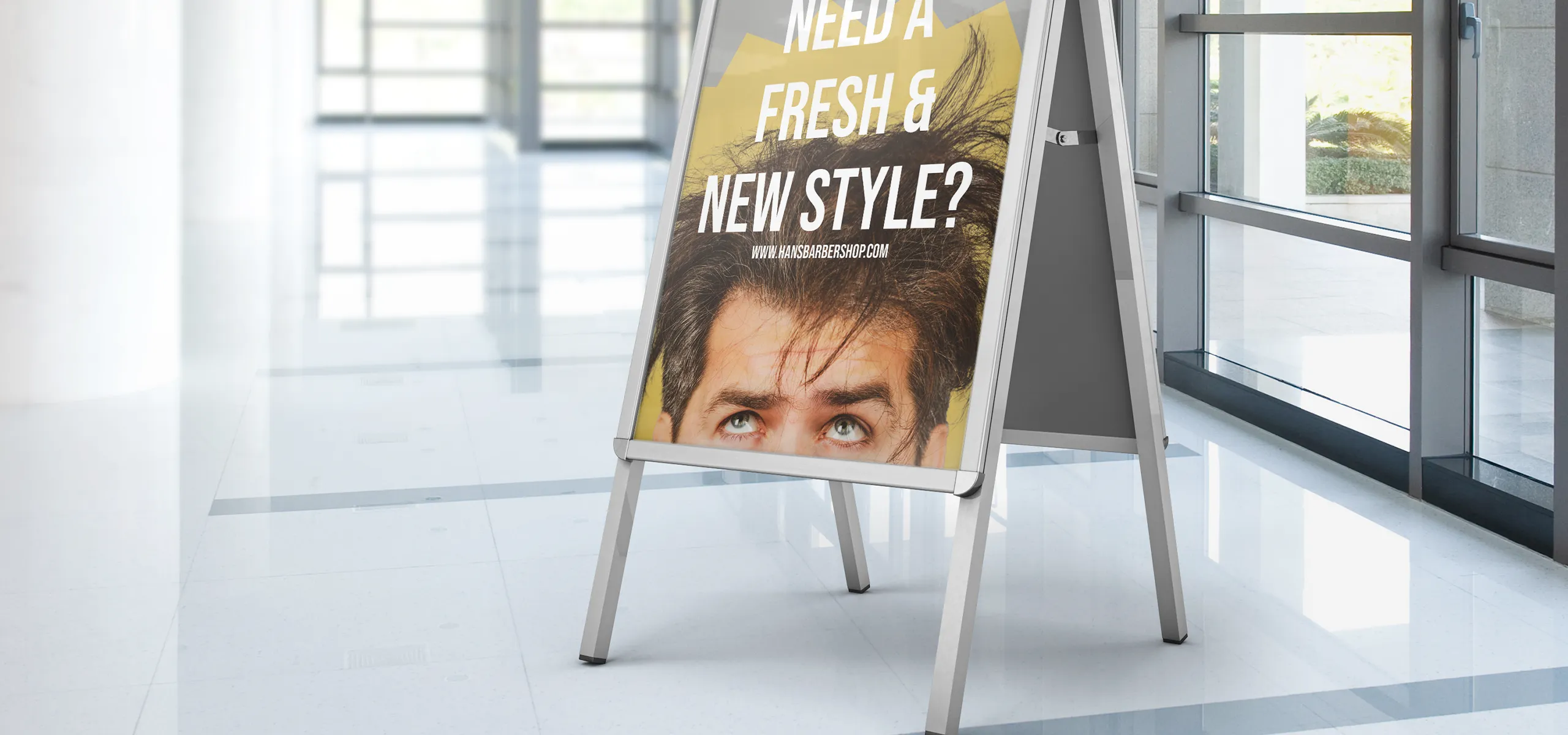 Advertising A-board with a poster placed indoors by the windows