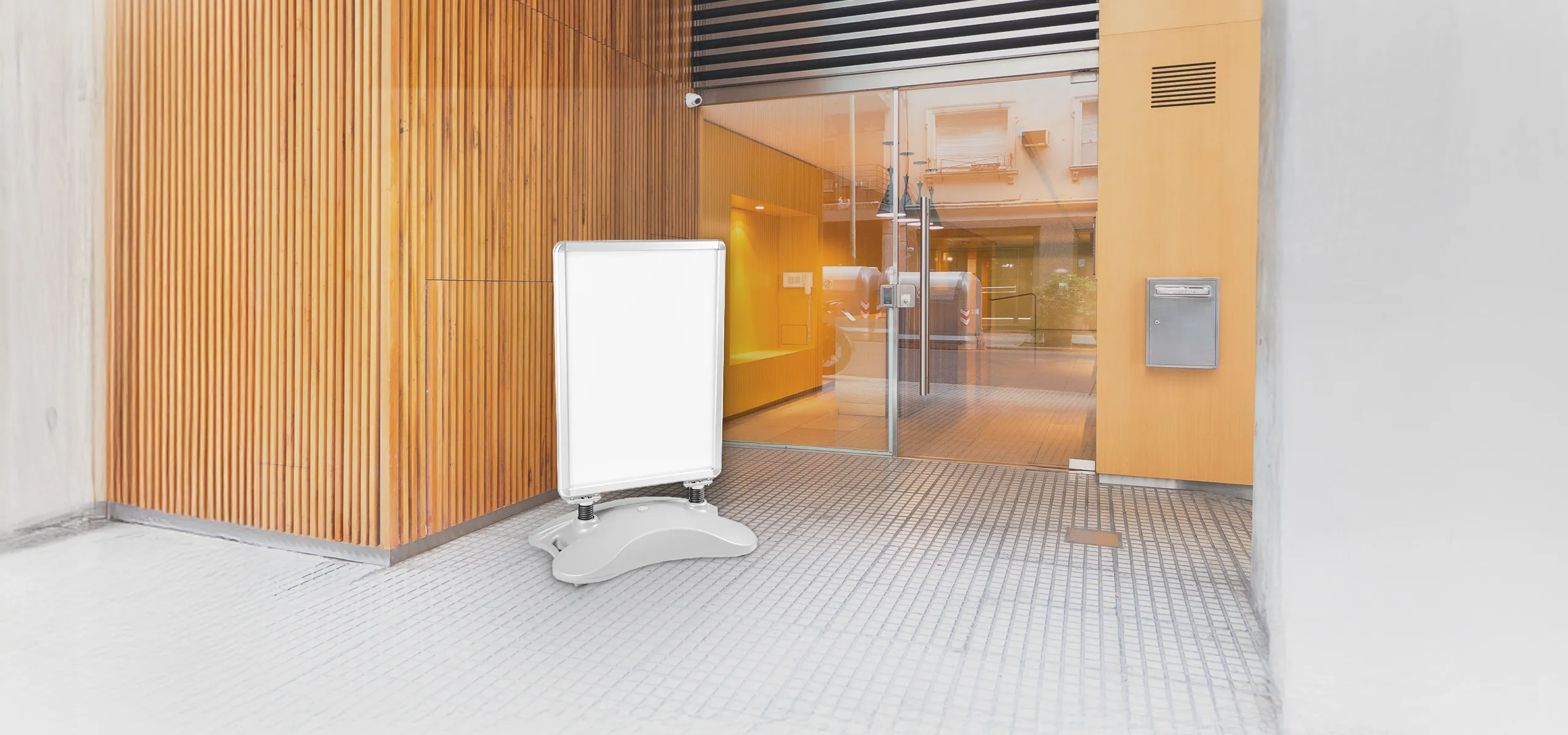 Advertising A-board with weighted base placed by a building entrance