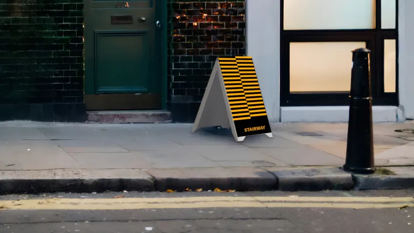 Double-sided PVC advertising A-board with print placed on the pavement in front of a premises