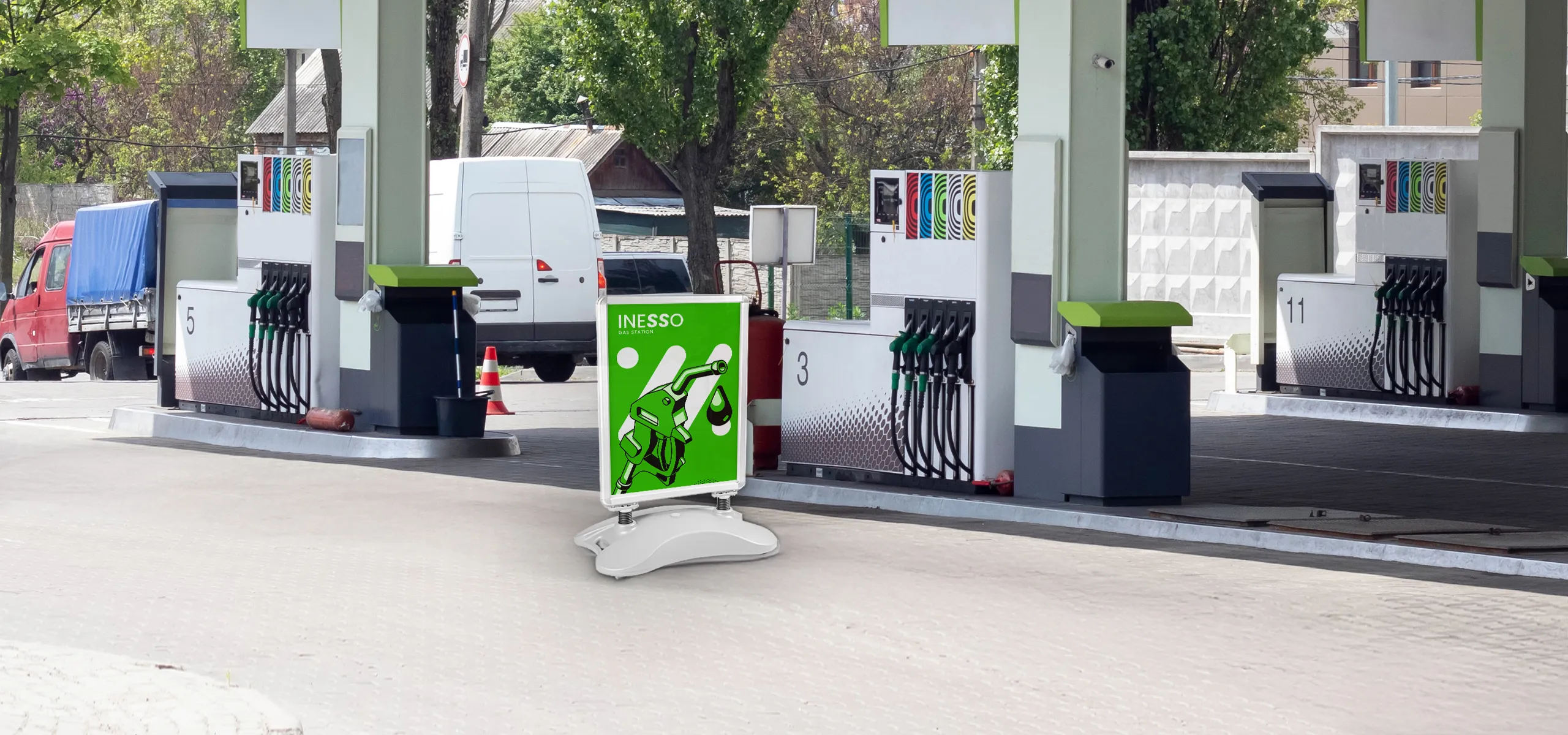Outdoor advertising A-board with weighted base and print placed at a petrol station
