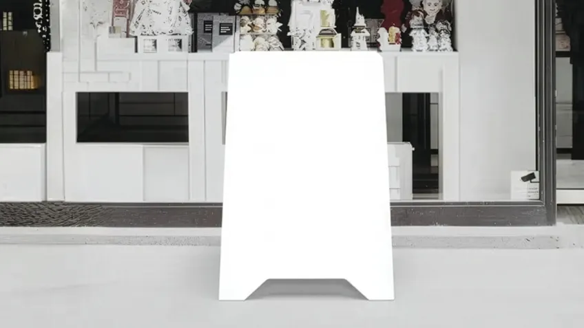 Double-sided PVC advertising A-board placed in front of a shop window
