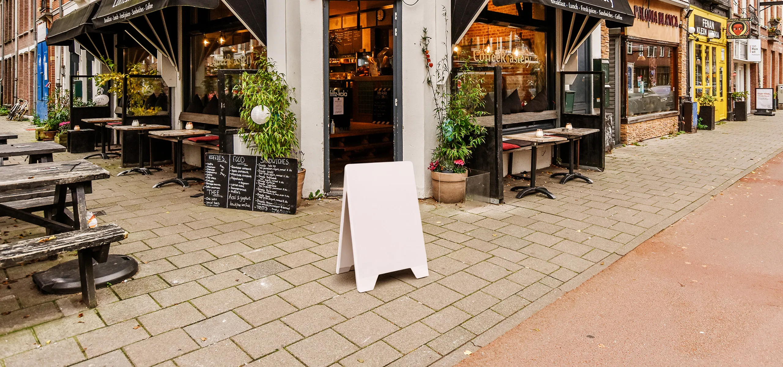 Double-sided PVC advertising A-board with menu placed in front of a restaurant