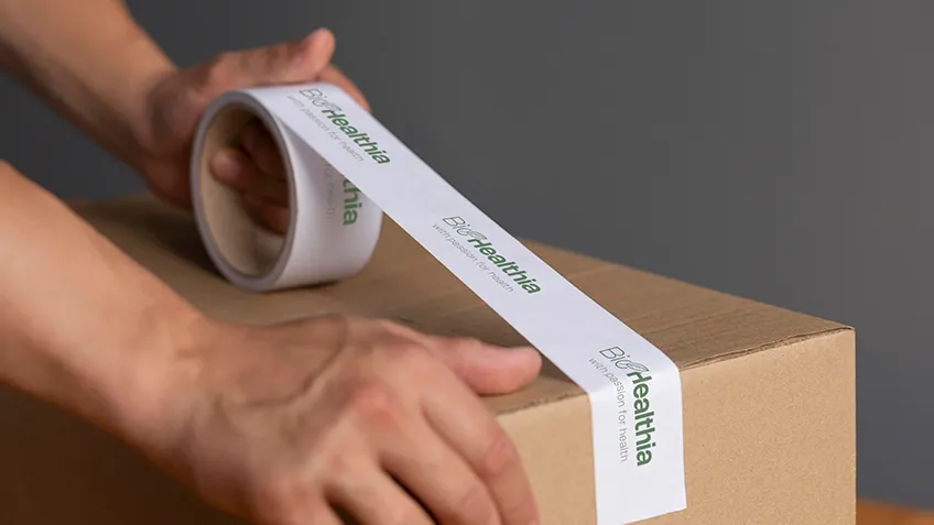 Pink self-adhesive tapes with print on a desk