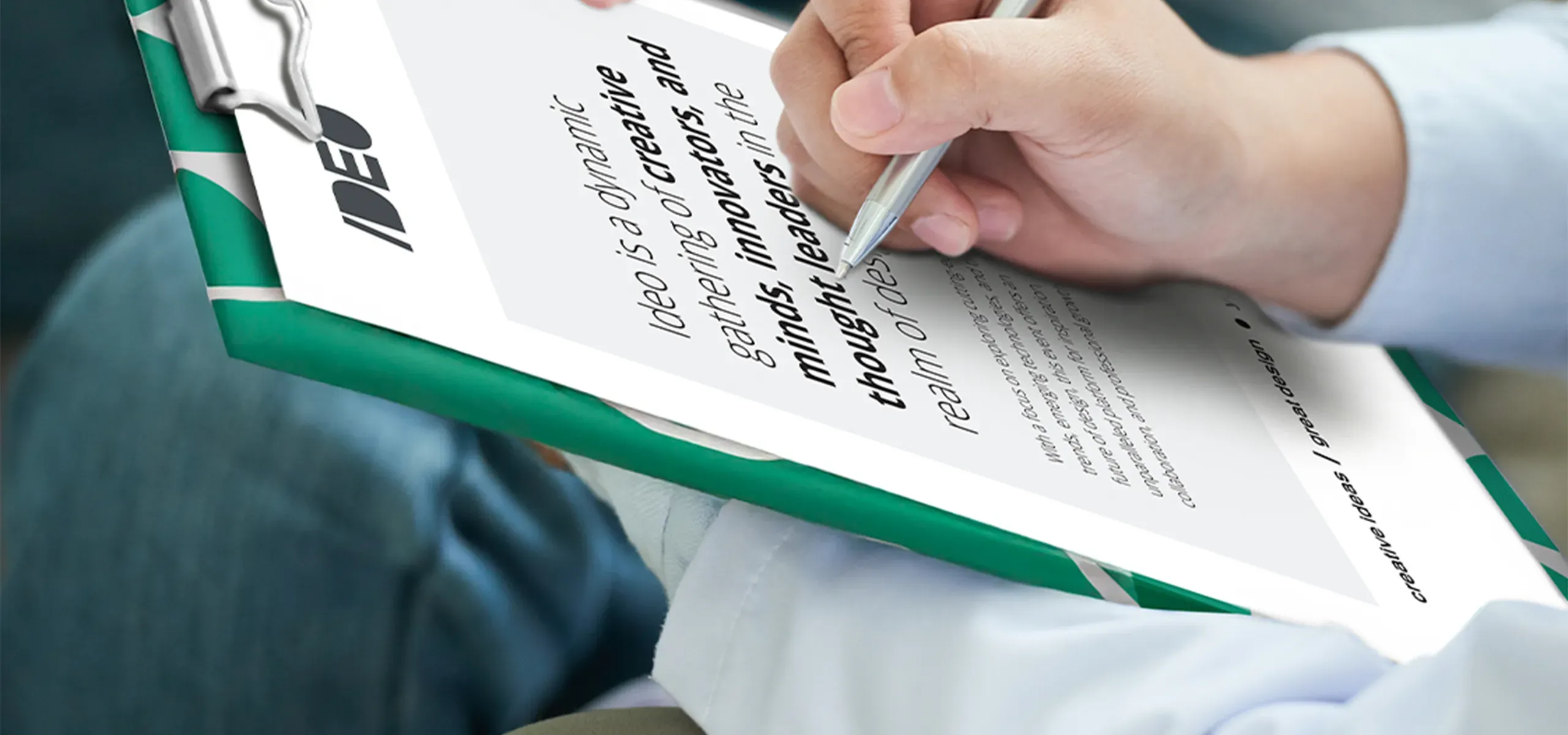 Close-up of an A4 clipboard with document and metal clip while writing