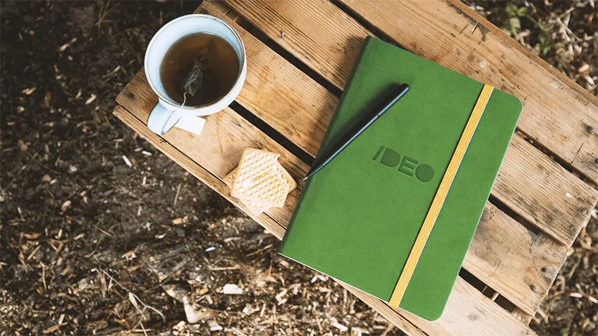 Green A5 weekly diary in a soft cover with logo and yellow elastic band